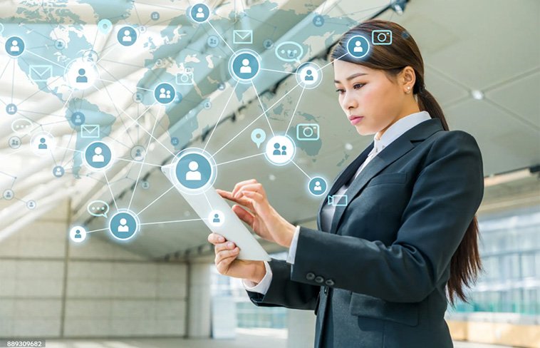 Business woman holding a tablet with networking hologram