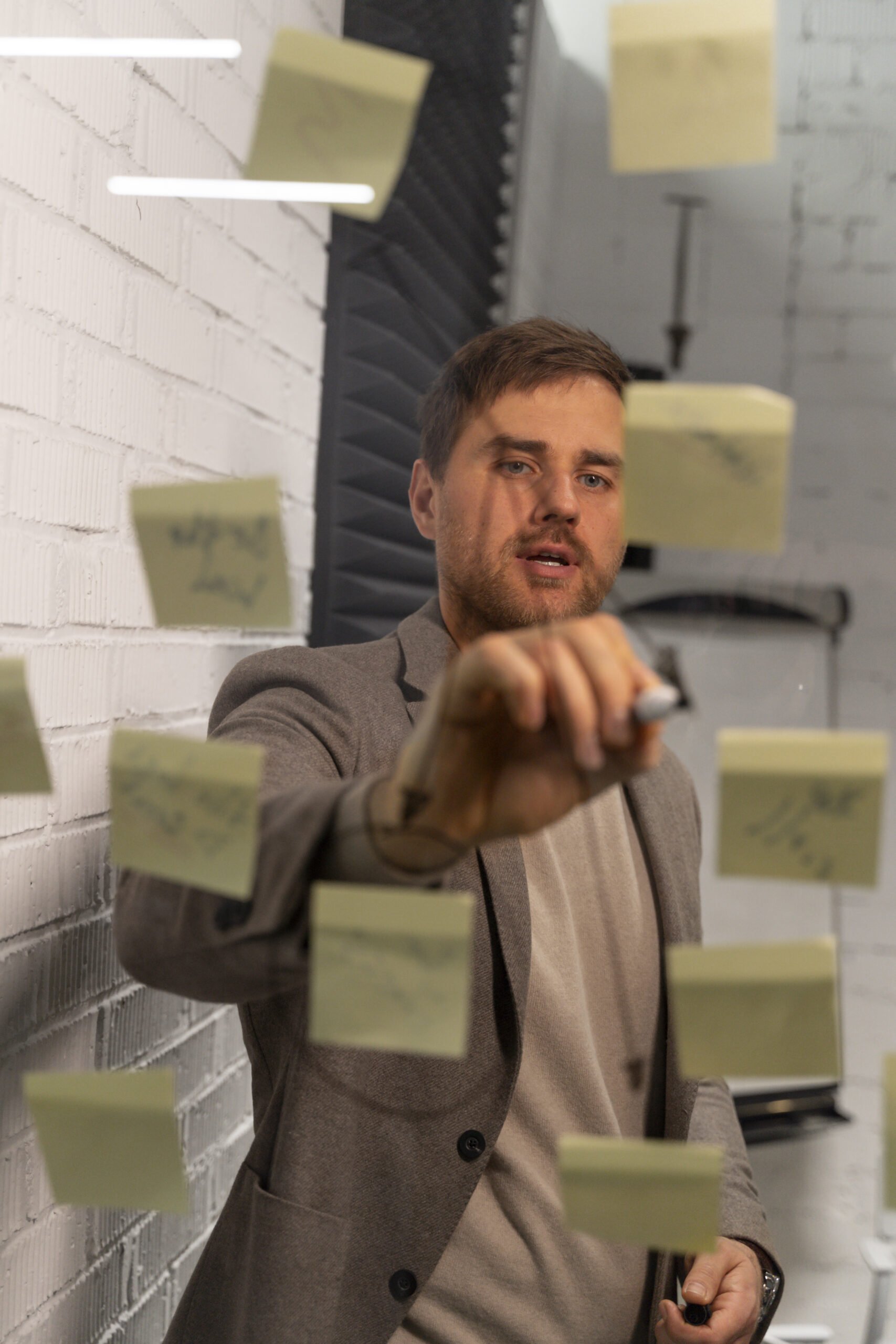 Business Owner drawing lines between stick notes