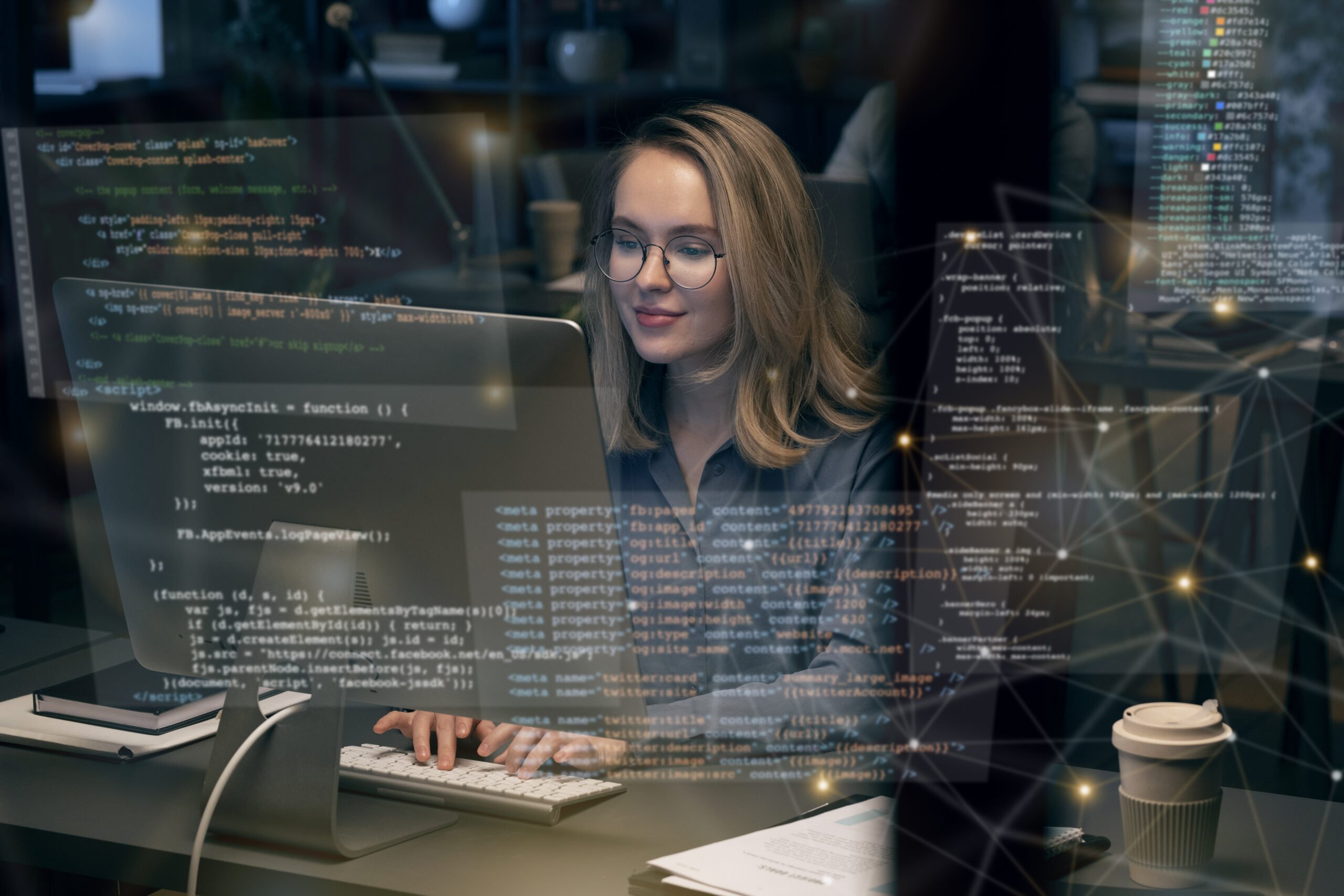 a blonde girl wearing glasses and sitting on her desk wriitng codes and programming holograms in front of her