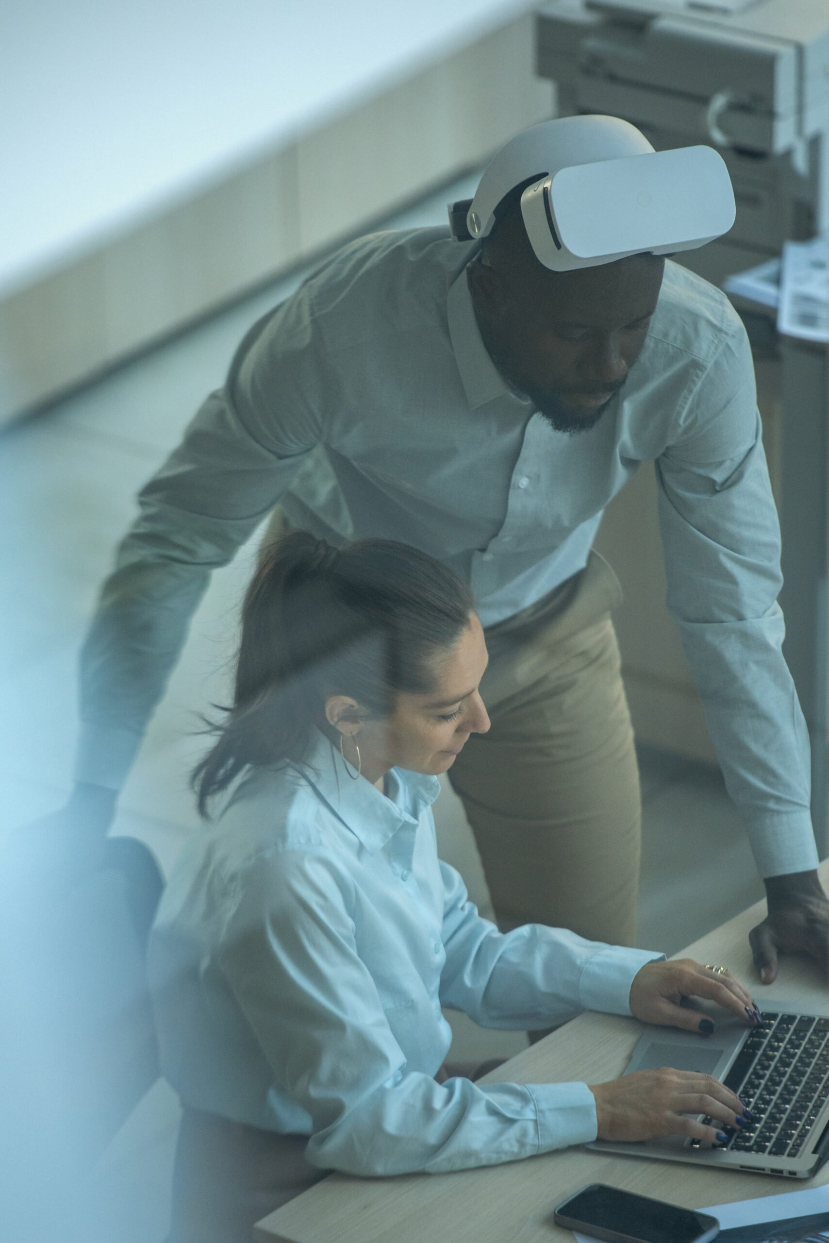 A man wearing VR Explaining something to his intern