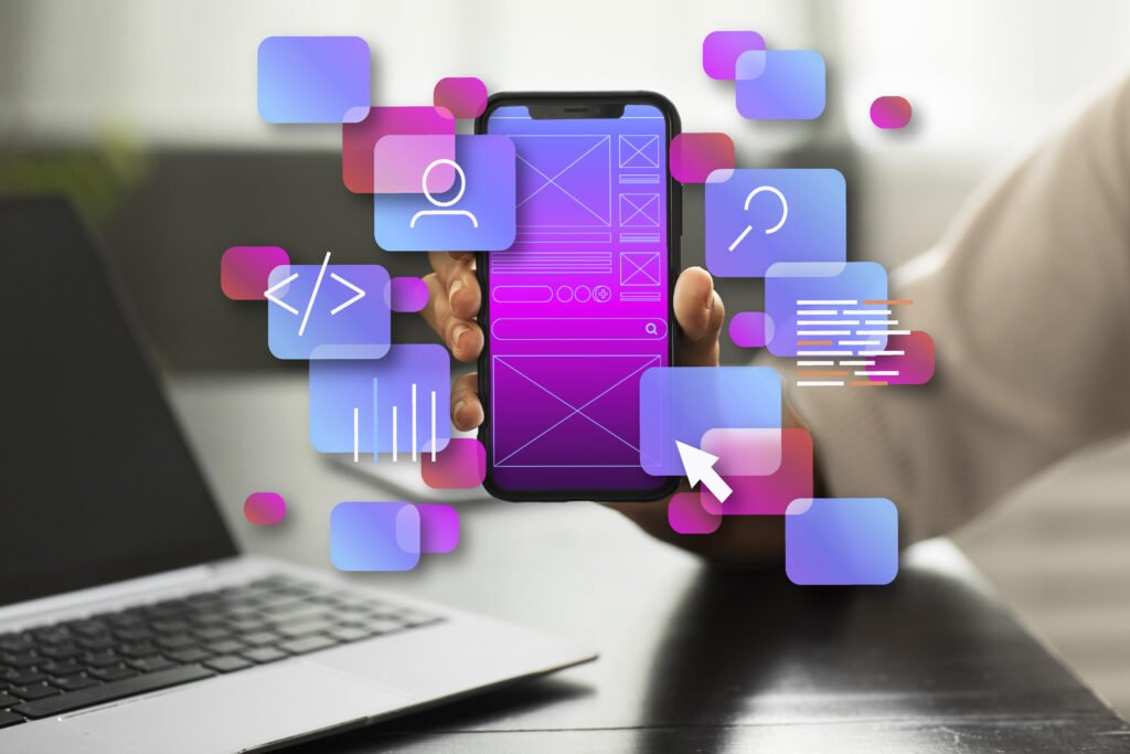 a presentation of wireframe in side a phone theme is pink and purple that a man hold and web and graphics icons in the foreground the and