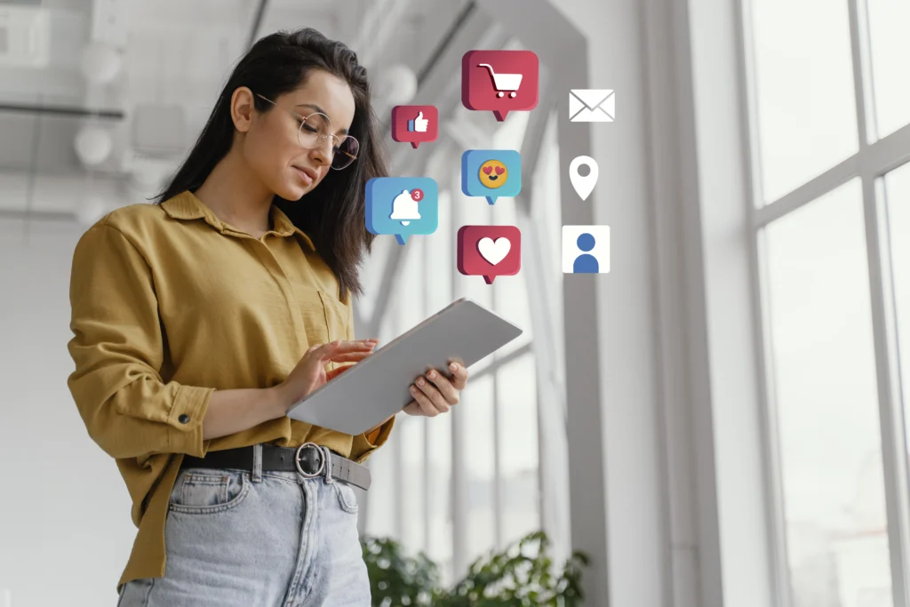 Girl employee holding a tablet and social media & engagement icon around it