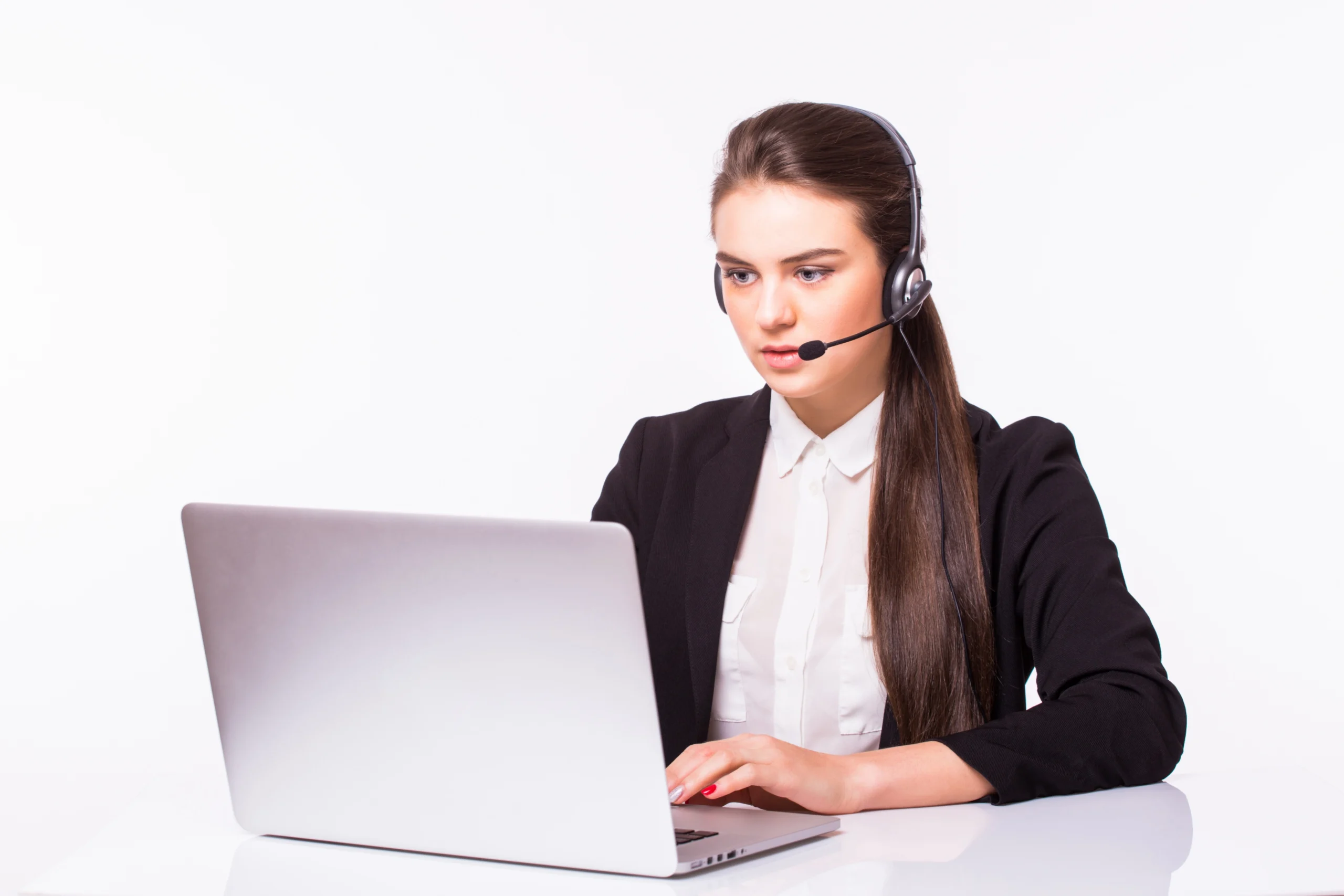 Woman working in call center wearing her suite and working on her laptop with white background