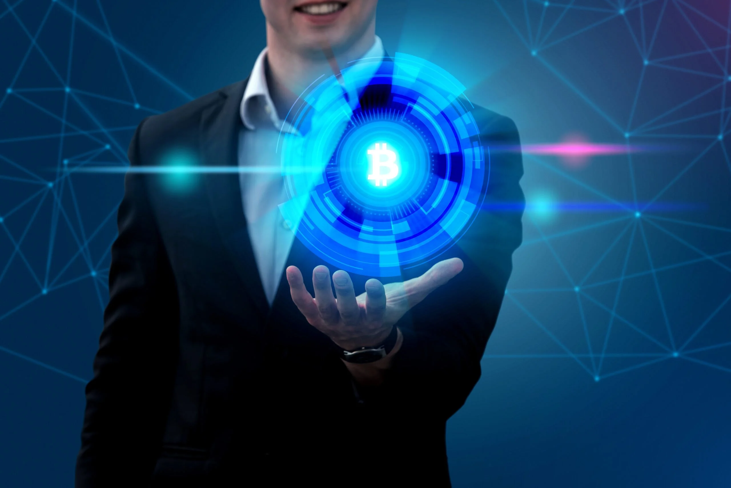 A man holding an electric blue icon in a hologram while smiling and wearing his suite and blue background showing networking